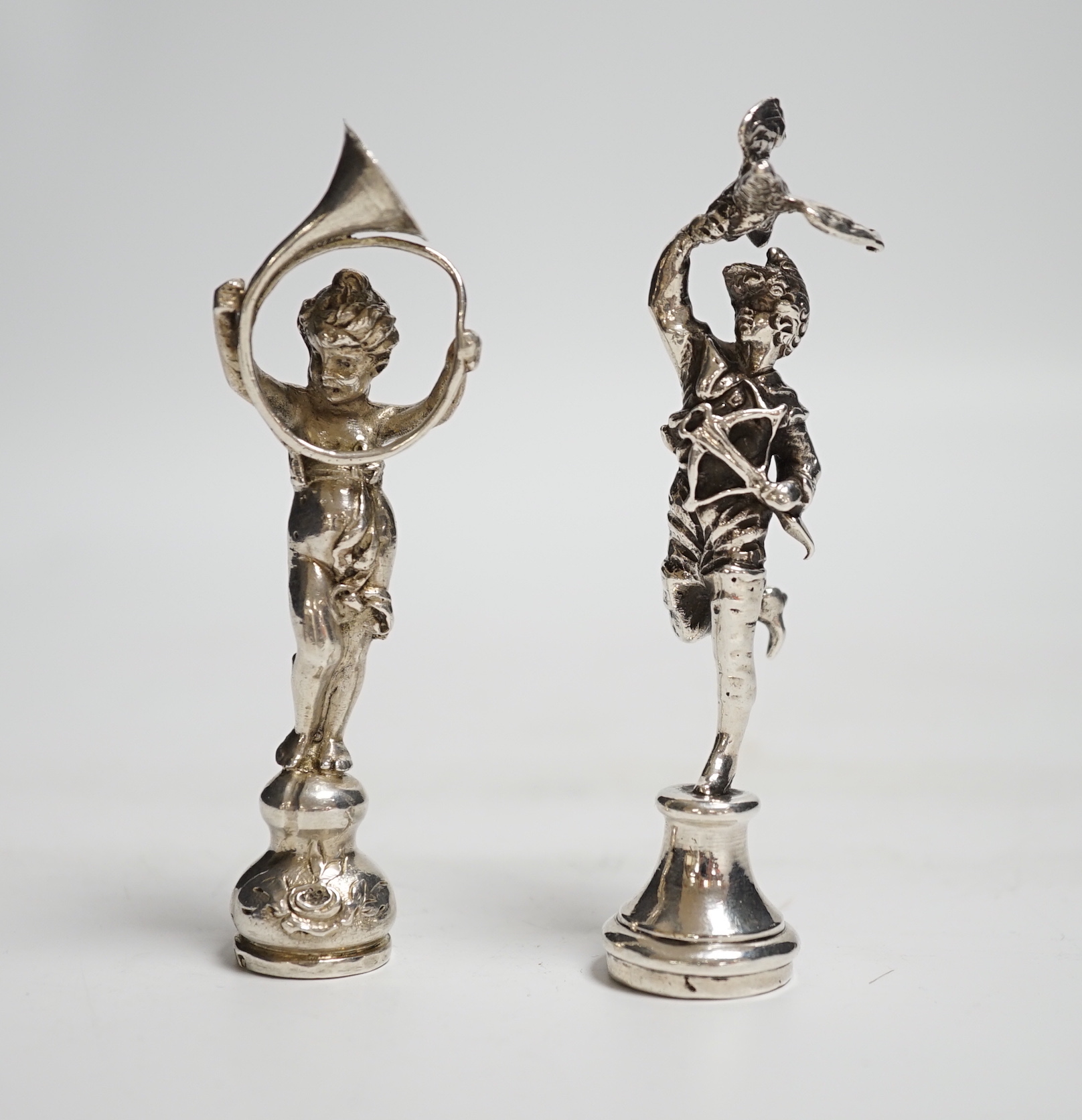 Two silver figural seals, child with French horn, import marks for Berthold Muller, London, 1894, 9cm and gentleman with eagle and crossbow, Berthold Muller, London, 1910.